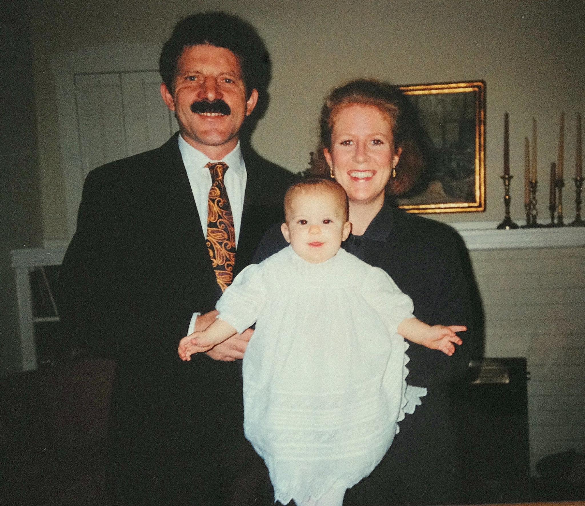 Francesco holding Sarah at her baptism in 1994