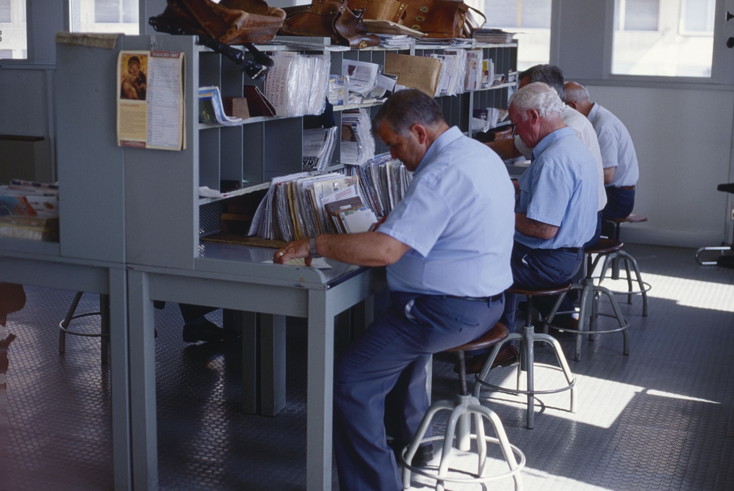 Mailworkers sorting letters in the post office